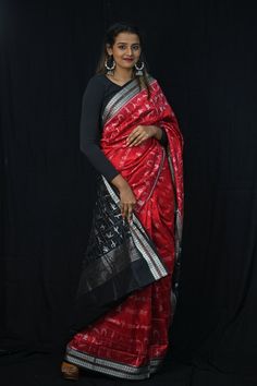 Exclusive hand-woven Sambalpuri silk saree with tribals. Finest pure handwoven sambalpuri ikat silk saree with traditional motifs woven by the master weavers of Sambalpur, Odisha. It has lovely patterns and is world-famous for its stunning colours, texture and designs. Occasion: Party Wear Fabric: Sambalpuri Primary Color: Red Secondary Color: Black Material: Mulberry Silk/ Sambalpuri Silk Pattern: Motif Border Type: Ikat Border Size: Medium Blouse Piece: Included Care: Dry Clean Disclaimer : This is a genuine handwoven piece, unevenness in the selvedge and weave could be expected and colours may fade or bleed due to the traditional dyeing method employed. Black Pre-draped Saree With Zari Weaving For Puja, Black Silk Handloom Pre-draped Saree, Black Pre-draped Saree With Traditional Patterns, Black Handloom Pre-draped Saree For Puja, Black Silk Pre-draped Saree For Navratri, Black Handloom Pre-draped Saree For Festivals, Black Katan Silk Pre-draped Saree With Zari Weaving, Festival Black Banarasi Silk Pre-draped Saree, Black Banarasi Silk Pre-draped Saree For Festivals