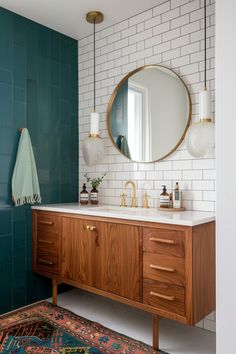 a bathroom with a large mirror and wooden cabinet in the corner, along with a rug on the floor