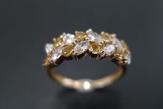 a yellow and white diamond ring sitting on top of a table