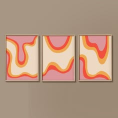 three abstract paintings hang on the wall