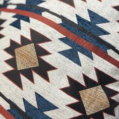 an old native american blanket with red, white, and blue designs on it's edges