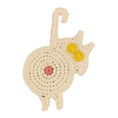 a crocheted white cat with yellow eyes on it's head and tail