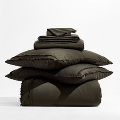 pillows stacked on top of each other in front of a white background