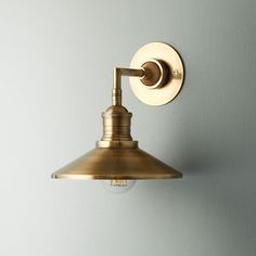 a light that is on the wall next to a white wall with a blue background