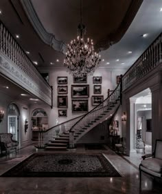 a large foyer with chandelier and stairs leading up to the second floor area