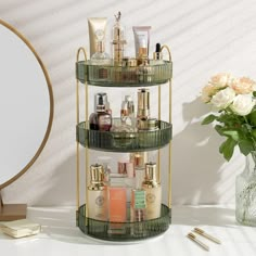 a three tiered shelf with cosmetics and makeup products on it next to a mirror