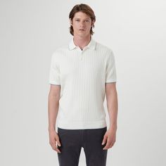 Short-sleeved solid vertical stripe stitch knit polo in cotton blend with three button placket and contrast tipped collar and armbands. Classic Striped Polo Sweater With Ribbed Collar, Classic Striped Polo Sweater With Polo Collar, Classic Collared Polo Sweater With Contrast Stripes, White Collared Polo Sweater With Ribbed Cuffs, White Collared Polo Sweater With Ribbed Collar, Classic Short Sleeve Polo Sweater With Striped Collar, Classic Cotton Polo Sweater With Striped Collar, Classic Ribbed Cotton Polo Shirt, Classic Ribbed Polo Shirt With Polo Collar