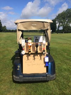 the back end of a golf cart with beer bottles in it