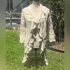 Nwt Stunning, Feminine, & Fun, This Eye-Catching Hand-Crocheted 100% Cotton Flounce Coat In Natural Will Be A Great Addition To Your Wardrobe. Made In The Usa. This Unlined Coat Has Long Sleeves & Flounce/Ruffle Lapel & A Beautiful Pattern Throughout. There’s Scalloping On The Sleeve Edge, Lapel & Collar, & Hem For A Feminine Touch. As This Is Handcrafted, The Pattern & Exact Measurements May Vary (See Pictures Showing Back Pattern) This Fun, Unique Coat Is Unlined & Machine Washable. If You Wan Fitted Crochet Cotton Outerwear, Cream Crochet Long Sleeve Outerwear, Long Sleeve Outerwear With Crochet Trim For Fall, Fitted White Crochet Outerwear, Fitted Cardigan With Crochet Trim For Fall, Fitted Fall Cardigan With Crochet Trim, Fitted Crochet Trim Cardigan For Fall, Long Sleeve Crochet Lace Outerwear For Fall, Bohemian Cream Open Knit Outerwear