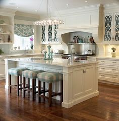 the kitchen is clean and ready to be used for cooking or eating, with stools around the island