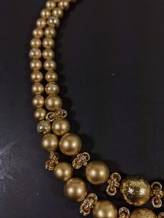 This vintage necklace has 2 strands of gold tone beads. It measures 18 inches long with a hook style clasp. It has only very light wear. R Gold Double Strand Pearl Necklace For Formal Occasions, Formal Gold Double Strand Pearl Necklace, Gold Multi-strand Pearl Necklace, Formal Gold Pearl Necklace With Polished Beads, Multi-strand Gold Jewelry For Celebration, Gold Double Strand Pearl Necklace For Jewelry Making, Gold Long Single Strand Necklace, Vintage Gold Polished Beads, Vintage Polished Gold Beads