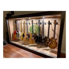 guitars are lined up in a display case