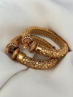 Antique gold finish kada. Amazing detailing.  openable screw kada ( set of 2) Style tip- Pair it with any beautiful traditional outfits  and flaunt with Unique style of collection from us. Perfect match for Festival and Traditional wear.  Take Care Tips-  Kee away from perfume, Hair spray and. Moisture.  Store in dry place , Ziplock bag or Airtight box.    Clean with dry cloth.  Jewellery is the last thing you should wear and first thing you should remove.  -------------------------------------- Traditional Luxury Bangle With Intricate Design, Gold Toe Ring Jewelry For Diwali, Diwali Puja Bangle Jewelry, Gold-plated Temple Jewelry Bangle For Festivals, Gold Plated Temple Jewelry Bangle For Festivals, Temple Style Gold-plated Bangle For Festivals, Temple Style Gold Plated Bangle For Festivals, Gold Plated Bangle For Puja And Festivals, Gold Hand Set Cuff Bracelet For Festivals