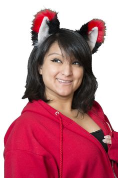 a woman in a red hoodie with cat ears on her head