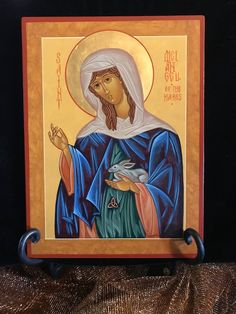 an icon of the virgin mary holding a dove