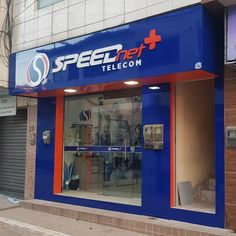 a blue store front with the words speed net and telecom on it's side