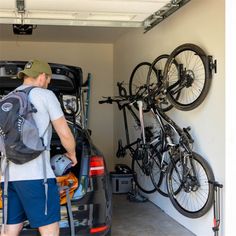 a man is loading his bike into the back of a car