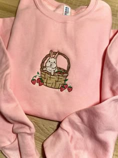 Introducing our Strawberry Basket Bunny Embroidered Sweatshirt 2D Crewneck Sweatshirt, a delightful and charming addition to your wardrobe. Designed for both men and women, this sweatshirt is a perfect blend of comfort, style, and versatility. At first glance, the detailed embroidery of a cute bunny nestled in a basket of fresh strawberries catches your eye. The intricate stitching brings the design to life, adding a touch of playfulness to your outfit. Made with precision and care, this embroid Pink Sweatshirt Embroidered, Cheap Cute Embroidered Sweater, Cheap Pink Embroidered Sweater, Strawberry Embroidered Sweatshirt, Spring Floral Embroidery Sweatshirt, Cute Embroidery Sweatshirts & Hoodies, Pink Long Sleeve Hoodie With Embroidered Logo, Cute Embroidered Long Sleeve Sweatshirt, Cute Long Sleeve Embroidered Sweatshirt