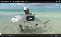 a man holding a large fish in the ocean with caption that reads, fly fishing for gts on christmas island mind