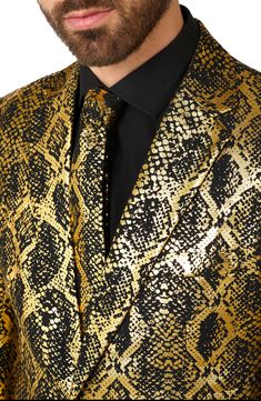 Shimmering snakeskin patterns accent this shiny suit for you to hit the dancefloor in. Jacket have four-button cuffs; chest pockets; front pockets; interior pockets; vents Trousers have zip fly closure; front pockets; back pockets Lined 100% polyester Machine wash, line dry Imported Model stats: 6'1" height, 32" waist. Model is wearing size 42. Fitted Gold Suit For Holiday, Fitted Gold Sets For Costume Party, Luxury Gold Suit For Party, Luxury Gold Sets For Party, Gold Formal Sets For Fall, Gold Party Sets For Fall, Notch Lapel Suit, Snakeskin Pattern, Fabric Gift Bags