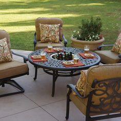 the patio furniture is set up outside on the patio with pillows and placemats