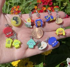 a person holding a penny in their hand with many different keychains on it