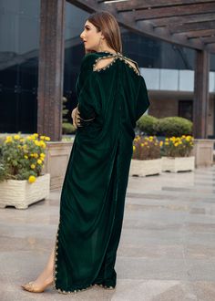 Deep forest green Velvet Kaftan delicately handworked with dabka, nakshi and zardozi on the neckline, shoulder slits, sleeves and front and back hemline and side slits.