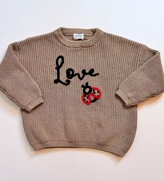 "Custom Baby and Toddler Sweaters with Hand Embroidered Love \"bug\" in the form of a lady bug.  The lady bug has french knots for spots! Celebrate Valentine's Day or just how special your little one is!  Special little heart at back neck line too! Pick your color and size.  Embroidery will be in the colors shown (black and red) To complete your order, please select your sweater size, color from the drop-down menus. This style has Love Bug (with ladybug)  on front, small red heart on back.  *Please read ALL details below ITEM DETAILS This listing is for a single sweater. You will find sizing information in the photos-so measure and compare to a similar garment for best fit.  They fit generously, but age is not always aligned with size!  100% cotton in rib stitch CARE INSTRUCTIONS For best Embroidery Sweater Diy, Valentines Day Kids, Small Red Heart, Baby Jumpers, Baby Ladybug, Pull Bebe, Toddler Valentines, Rib Stitch, Toddler Sweater