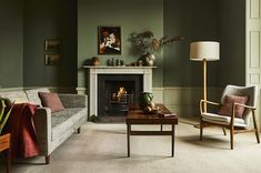 a living room filled with furniture and a fire place next to a window in front of a fireplace