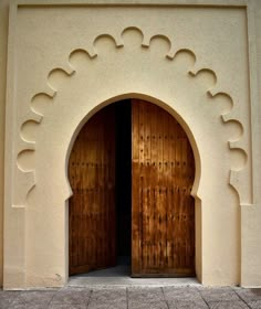 an entrance to a building with wooden doors