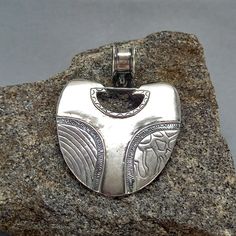 A unique handcrafted necklace made of 925 sterling silver, featuring a boho hippie pendant with a geometric ethnic tribal design. This artisan jewelry piece is truly one of a kind, perfect for those who appreciate distinctive and elegant accessories. * 100% polished solid sterling silver * .925 trademark stamp Sterling  Silver * Solid sterling silver weight: approx. 7.5 Grams * Length: 60 mm  / 2.36 inches  *  Width: 45 mm  / 1.77 inches * Inner Bail diameter: 10 mm / 0.38 inches * Solid sterlin Artisan Silver Engraved Necklaces, Artisan Sterling Silver Necklace For Festival, Artisan Silver Heart Pendant Necklace, Sterling Silver Nickel-free Necklace For Festivals, Unique Antique Silver Pendant Jewelry, Artisan Silver Necklace For Festivals, Unique Antique Silver Sterling Silver Necklace, Artisan Silver Necklace For Festival, Sterling Silver Necklace With Large Pendant For Festival