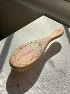 a wooden spoon sitting on top of a table next to a white window sill