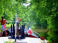 a person standing on the back of a boat