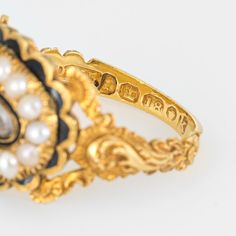 Antique Georgian era memorial ring (circa 1825) crafted in 18 karat yellow gold.   Natural pearls measuring (average) 2.5mm border an oval compartment that holds natural hair. The pearls are in very good condition showing good lustre. The glass case protecting the braided hair is in excellent condition and free of cracks or crisps.       The ring is a wonderful example of Georgian era memorial jewellery with rich floral and scrolled details to the side shoulders. The pearls border a lock of hair Oval Gold Pearl Ring With Cabochon, Gold Oval Cabochon Pearl Ring, Gold Oval Hallmarked Pearl Ring, Gold Hallmarked Oval Pearl Ring, Oval Hallmarked Gold Pearl Ring, Gold Pearl Cabochon Ring For Wedding, Gold Cabochon Pearl Ring For Wedding, Victorian Oval Enamel Ring For Anniversary, Victorian Yellow Gold Pearl Ring With Rose Cut Diamonds