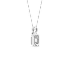 Embrace elegance with our Twisted Emerald Bezel Pendant Necklace. It features a brilliant emerald-shaped lab-grown diamond, delicately set in a sleek bezel setting, ensuring it catches the light from every angle. The twisted bail design adds a unique twist, symbolizing the intertwining of classic and contemporary styles. Whether dressing up for a special occasion or adding a touch of sophistication to your everyday look, this diamond pendant necklace is the perfect choice. Classic Emerald Necklace With Diamond Accents For Formal Occasions, Classic Emerald Necklace With Diamond Accents For Formal Events, Classic Silver Emerald Necklace With Diamonds, Baguette Cut Diamond Emerald Necklace For Anniversary, Classic White Gold Emerald Necklace With Diamond Accents, Classic Emerald Pendant Necklace With Diamond Accents, Classic Emerald Necklace With Bezel Setting, Classic Emerald Necklace With Brilliant Cut Cubic Zirconia, Formal Emerald Necklace With Bezel Setting