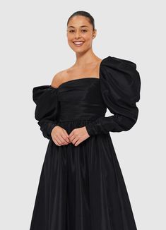 PRODUCT DESCRIPTION Premium off-shoulder gownStrapless necklineZipper detail necklineFitted ruched bodiceGathered puff sleeveElastic shoulderRuched zip cuff openingInvisible back zip closurePleated A-line silhouetteFully lined SIZE & FIT 6 8 10 12 14 16 Collar 77.5 82.5 87.5 92.5 98.5 104.5 Bust 80 85 90 95 101 107 Waist 67 72 77 82 88 94 Sleeve Length 47 47 47 47 47 47 Sleeve Opening 18.5 19.5 20.5 21.5 22.5 23.5 Back Length 109.8 111 112.2 113.4 114.6 114.6 Hem Circumference 471 475 479 483 487 494 Model is 5’10” (178 cm) and wears a size 8Bust: 31.5” (80cm) / Waist: 24” (61cm) / Hips: 36” (91cm) Luxury Voluminous Puff Sleeve Midi Dress, Black Midi Dress With Puff Gathered Sleeves, Luxury Black Puff Sleeve Dress With Gathered Sleeves, Black Midi Dress With Gathered Neckline, Luxury Black H-line Midi Dress, Bustier Midi Dress, Leo Lin, Tara Milk Tea, Off Shoulder Gown