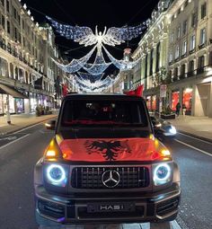 the mercedes benz truck is decorated with christmas lights and angel wings on it's hood