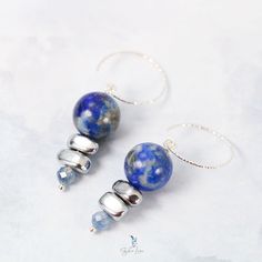 These elegant Lapis Lazuli bead stones dangle drop earrings feature a beautiful deep blue 12 mm Lapis Lazuli beads dangle drop and two painted silver Hematite stone beads, a faceted blue Kyanite tiny bead drop at the end. The beads are on solid 925 sterling silver eye pin, hooked on a diamond cut texture 925 sterling silver ear wire. Add these elegant Lapis Lazuli, Hematite and Kyanite beads dangle drop earrings to your everyday fine jewelry collection or as a gift for your loved one. Materials: 925 sterling silver, Lapis Lazuli, UV hematite, kyaniteDimensions: 1.84 x 0.46 in Jewelry Care: See more information about how to care for your jewelry here. Shipping Policy: Orders will be shipped within 1-3 business days. Economy shipping will take 7-14 days to arrive and standard shipping is 1- Silver Eye, Lapis Lazuli Beads, Hematite Stone, Blue Kyanite, Fine Jewelry Collection, Beaded Dangles, 925 Sterling Silver Earrings, Ear Wire, Diamond Cut