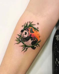 a panda bear tattoo on the arm