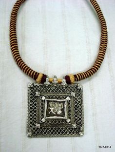 VINTAGE ANTIQUE COLLECTIBLE TRIBAL OLD SILVER PENDANT NECKLACE FROM RAJASTHAN INDIA. NICE DESIGN OLD SILVER PENDANT RE-STRUNG WITH COTTON CORD IN TRADITIONAL STYLE. GREAT PIECE FOR ETHNIC JEWELRY COLLECTOR OR FOR TRIBAL STYLE BELLY DANCE. SUBJECT OF THIS AMULET IS HINDU GODDESS LAXMI (GODDES OF WELTH) AND LORD GANESHA (GOD OF MIND AND LUCK).Length - 45 cm(17.7")we can adjust the length.Pendant size - 7/6.4 cmweight - 70 gramsMaterial - silver & original old worn piece. Silver Temple Necklace With Intricate Design For Puja, Silver Temple Necklace With Antique Finish For Festive Occasion, Engraved Jewelry For Festivals, Silver Jewelry With Intricate Design For Puja, Silver Temple Necklace With Antique Finish As Gift, Silver Jewelry With Antique Finish For Festivals, Traditional Engraved Necklaces For Puja, Silver Temple Necklace For Puja, Antique Finish Temple Necklace As Gift