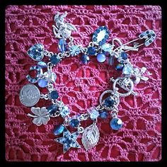 Gorgeous!! Whimsical Bracelet/Earring Set In Different Hues Of Blue. Charms: Bow, Safety Pin, Heart Key, Mother Of Pearl , Chereb, Heart, Horseshoe, Coin, Clover, Star, Leaf. In Between Each Charm Are An Assortment Of Crystal And Glass Beads. Crystal Flower Earrings With Gemstone That Dangles . So Pretty :) Blue Charm Bracelet For Party, Blue Jeweled Bracelets As Gift, Handmade Blue Dangle Charm Bracelet, Elegant Blue Nickel Free Charm Bracelet, Blue Charm Bracelet With Dangling Charms As Gift, Blue Charm Jewelry For Party, Blue Metal Charm Bracelet As Gift, Blue Jewelry With Dangling Charms For Jewelry Making, Elegant Handmade Blue Charm Bracelet