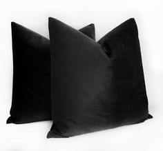 two black pillows sitting next to each other