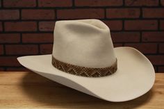 Inspired by the tall crown hat John Wayne wore in his last Western The Shootist (1976) Handmade to Order Crown: Front 6-1/4", Back: 6" Color: Bone (Also available in Granite) Brim: 4-1/2" raw w/slight upturn on sides Hatband: 1-1/4" snakeskin hatband Estimated delivery 8-12 weeks * Disclaimer: "The Shootist", is TM and © (or copyright) by Paramount Pictures. Any reproduction, duplication or distribution of these materials in any form is prohibited. This web site, its operators, including, but no Cowboys Hats, Cowboy Hat Styles, Tall Crown, Custom Cowboy Hats, Los Angeles Street, Creative Look, Color Bone, Crown Hat, Hat Styles