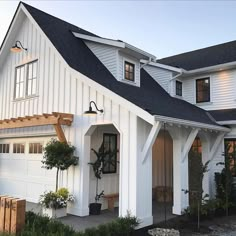 a white house with black roof and windows