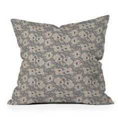 a blue and white floral pillow on a white background with a brown flower pattern in the middle