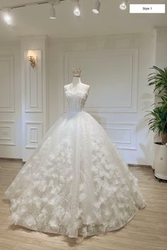 a white wedding dress on display in a room