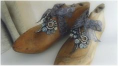 an old pair of wooden shoes with beading on them