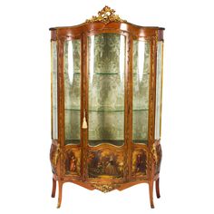 an ornate display cabinet with glass doors