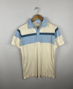 *ITEM DETAILS:Vintage 70s  Levis Collar Shirt Western Levis Stripe Polo Shirt Large  1970s Levis Rockabilly Tshirt Size L 👇🏻 Please be aware that all vintage items will usually show a few signs of wear or fading due to age, but anything visible such as stains or holes, and serious flaws have been photographed.For any further information on this item please contact us and we will be happy to help. *SIZE: LARGE  * ACTUAL SIZE MEASUREMENT: 👇🏻 *PIT TO PIT(WIDTH):24"INCHES *LENGTH(FROM SHOULDER): 28"INCHES    *ALL MEASUREMENTS ARE TAKEN WITH THE GARMENT FLAT ON THE GROUND *VIEW FULL SHOP HERE: *SHIPPING: (WITH ONLINE TRACKING NUMBER ) *DHL EXPRESS SHIPPING:4-6 BUSINESS DAYS *Don't Worry About Customs Tax or Fees. I usually Declare As 'Gifts' And Low Value  *PAYMENT (ACCEPT "PAYPAL" ONLY). * Retro Collared Polo Shirt With Graphic Print, Retro Collared T-shirt For Summer, Retro Collared Summer T-shirt, Summer Retro Collared T-shirt, 1970s Cotton Short Sleeve Tops, 1970s Style Cotton Short Sleeve Tops, 1970s Style Cotton Tops With Short Sleeves, Retro Camp Shirt With Graphic Print, White Vintage Camp Shirt With Relaxed Fit