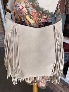 Ivory Leather Beaded Fringe Purse Each bag is unique and totally one of a kind! Room enough for all your daily essentials, this purse matches any bohemian style outfit and more. Featuring tassel and bead details, and so much fun fringe! Approx. 13" x 12" x 3" Zipper closure, 1 inside zipper pocket Chic Beige Fringe Shoulder Bag, Beige Fringe Tote Shoulder Bag, Beige Fringe Shoulder Bag For Travel, Beige Fringe Shoulder Bag For Daily Use, Chic Beige Fringe Bag, Beige Fringe Hobo Bag For Daily Use, Beige Fringed Hobo Bag For Daily Use, Bohemian Beige Bag With Fringe, Bohemian Cream Beaded Bag